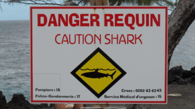 Cartel de advertencia de tiburones en la costa de Reunión